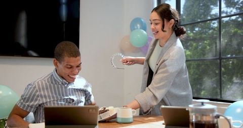 Celebratory office party with colleagues sharing desserts