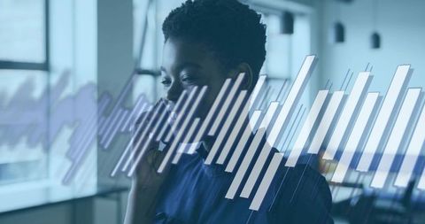Professional woman speaking on smartphone with data analytics overlay in modern office