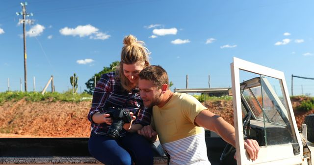 Young Couple Reviewing Photos on Camera Outdoors - Download Free Stock Images Pikwizard.com