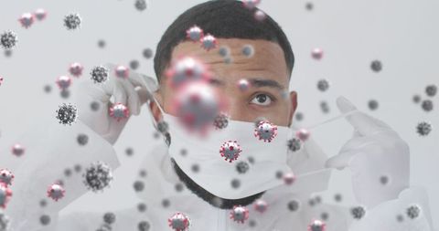 Health worker adjusting mask amid illustrative virus particles