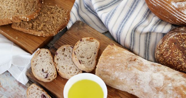 Assorted Baked Bread with Olive Oil on Rustic Table - Download Free Stock Images Pikwizard.com