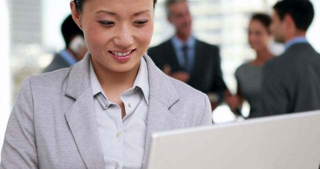 Asian Businesswoman Working on Laptop in Office Environment - Download Free Stock Photos Pikwizard.com