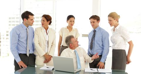 Diverse Business Team Discussing at Office in Front of Laptop - Download Free Stock Images Pikwizard.com