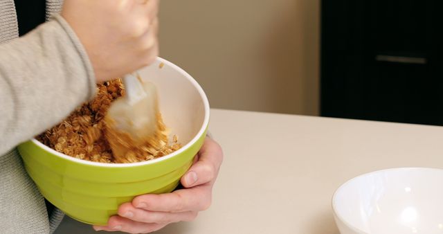 Person Mixing Granola in Green Bowl - Download Free Stock Images Pikwizard.com