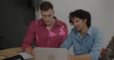 Innovative Business Team Collaborating on Laptop in Modern Office