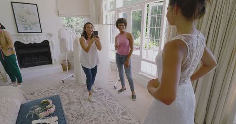 Bride Celebrating with Friends in Bridal Suite Before Wedding