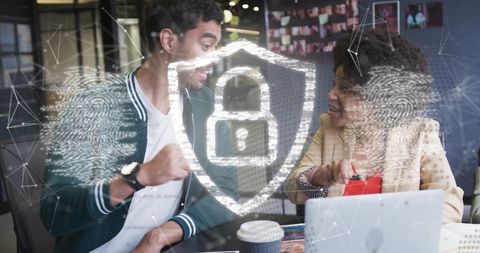 Fist-bumping colleagues celebrating cybersecurity win with biometric shield overlay