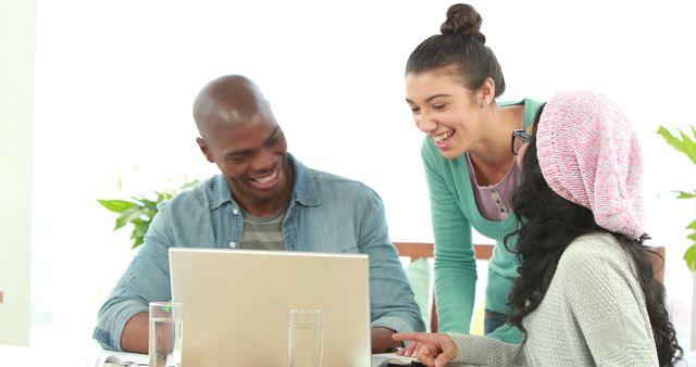 Smiling Diverse Team Collaborating on Laptop in Bright Office - Download Free Stock Images Pikwizard.com