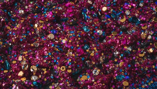 Magenta glitter mix with gold sequins and gem accents creating festive sparkle