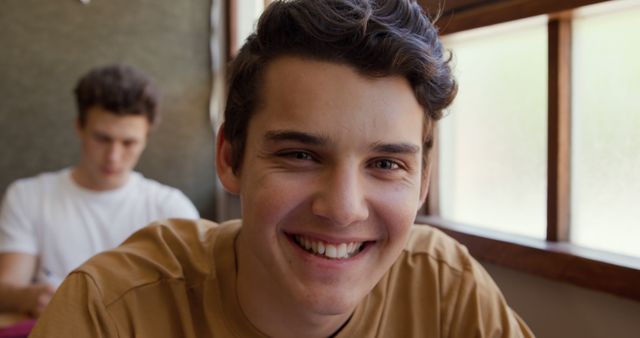 Smiling Young Man in Classroom Setting by Window - Download Free Stock Images Pikwizard.com