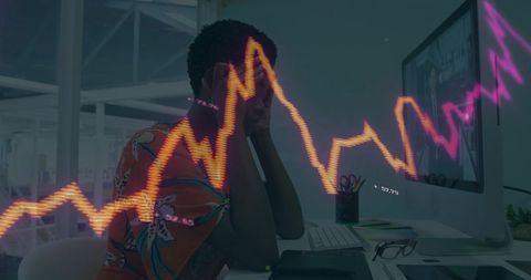 Stressed businesswoman with financial graph at modern desk