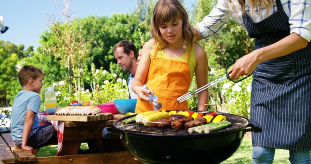 Family Enjoying Outdoor Barbecue in Sunny Garden - Download Free Stock Images Pikwizard.com