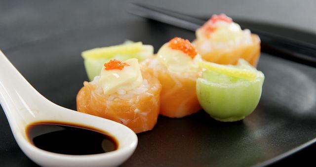 Assorted Sushi with Soy Sauce and Chopsticks on a Black Plate - Download Free Stock Images Pikwizard.com