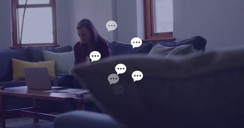 Focused Woman Reviewing Papers Near Laptop in Cozy Living Room