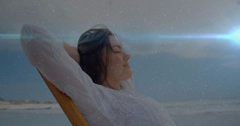 Serene Woman Relaxing on Beach Under Starry Sky