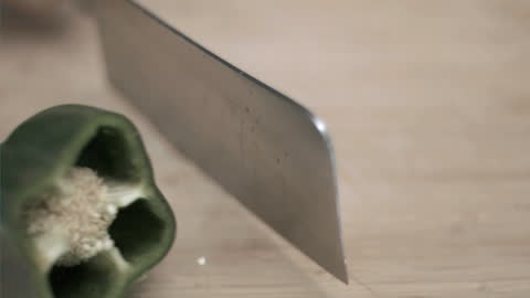 Cleaver Slicing Green Pepper in Slow Motion
