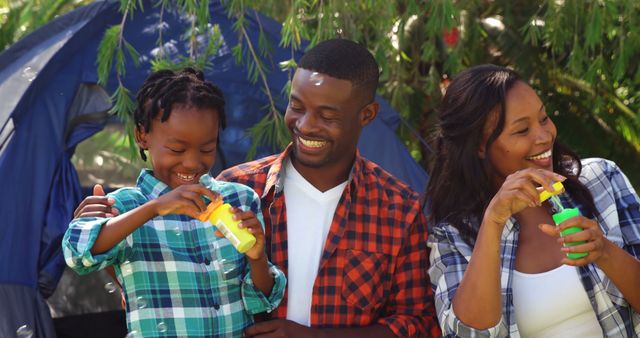 Happy African American Family Blowing Bubbles at Campsite - Download Free Stock Images Pikwizard.com