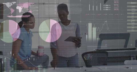 Diverse Businesswomen Analyzing Data with Digital Charts