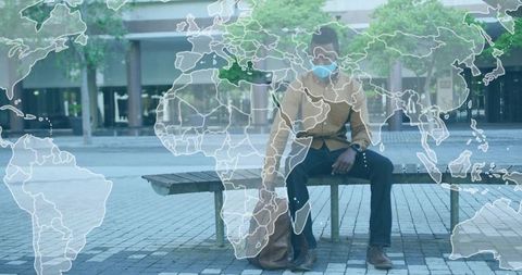 Man sitting alone with world map overlay, urban solitude