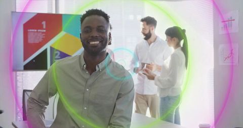 Confident black professional leaning on desk smiling during office presentation