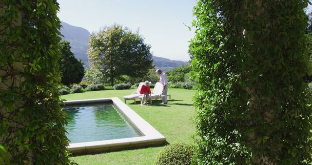 Senior Couple Relaxing by Pool in Scenic Backyard Garden - Download Free Stock Images Pikwizard.com