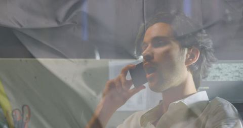 Businessman communicating by smartphone in modern office