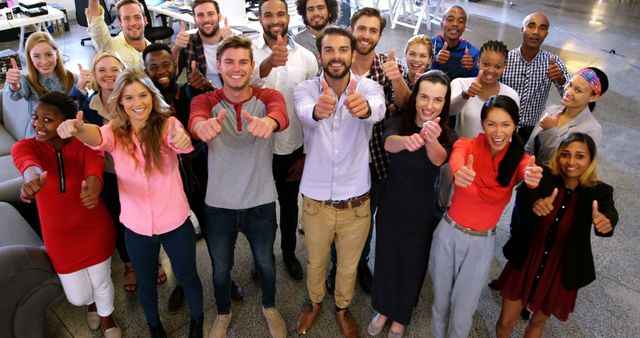 Diverse Team Showing Thumbs Up in Office - Download Free Stock Images Pikwizard.com