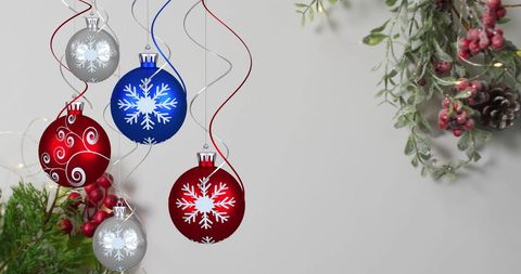Festive Christmas Ornaments with Snowflakes and Holiday Greenery