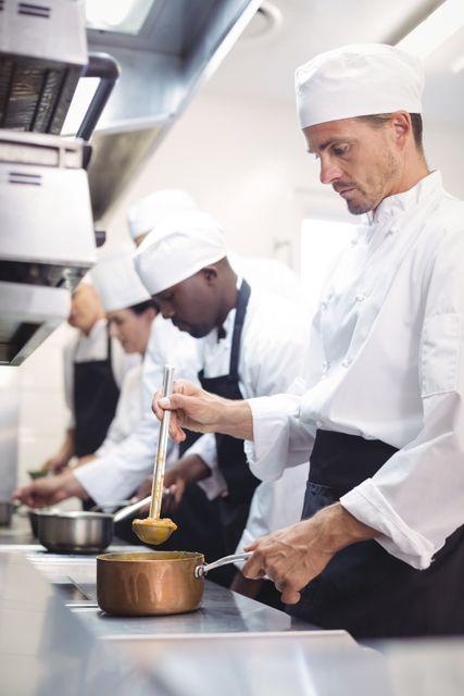 Team of chef preparing food in the commercial kitchen at restaurant