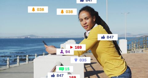 Young woman engaging on social media at seaside