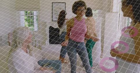 Curly-haired stylist leading home styling session with friends, casual denim outfit inspiration