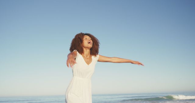 Joyful Young Woman Embracing Freedom at the Beach - Download Free Stock Images Pikwizard.com