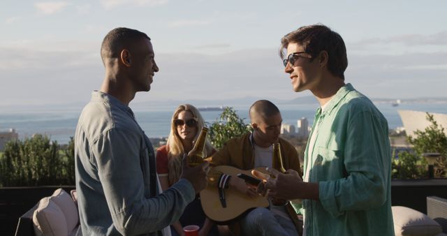 Friends Enjoying Rooftop Patio Gathering with Music - Download Free Stock Images Pikwizard.com