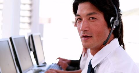 Friendly Call Center Agent with Headset Providing Customer Service