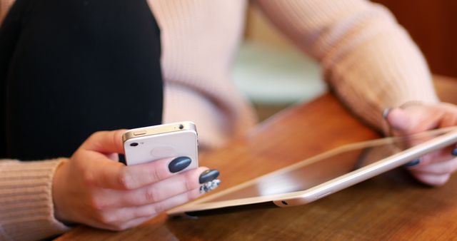 Close Up of Hands Using Smartphone and Tablet at Wooden Table - Download Free Stock Images Pikwizard.com