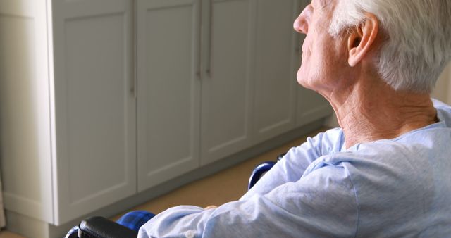 Elderly Man Sitting in Wheelchair at Home, Side View - Download Free Stock Images Pikwizard.com