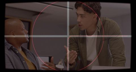 Office confrontation under hud targeting reticle, coworkers debating at desk in workspace