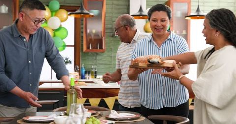 Senior Friends Enjoying Dinner Party Together at Home
