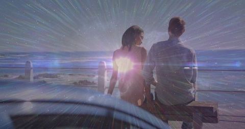 Romantic couple enjoying starry night at waterfront