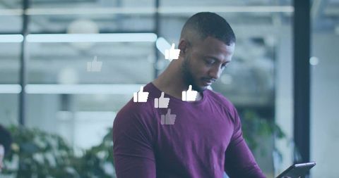 Man Engaged with Tablet in Modern Office with Social Media Interaction