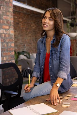 Creative designer thinking ideas over work desk