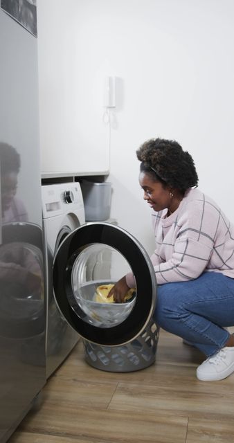 Woman Loading Laundry Machine in Modern Laundry Room - Download Free Stock Images Pikwizard.com