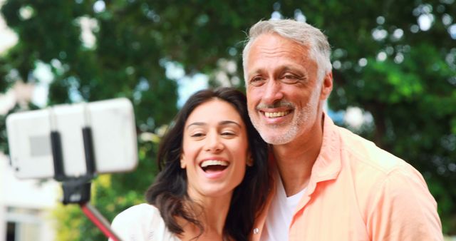 Smiling couple taking selfie in the city