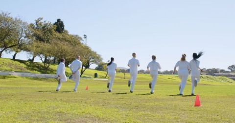 Female healthcare team jogging outdoors for wellness and team building