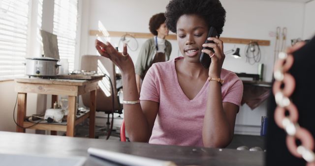 Young Woman Talking on Phone in Creative Workspace - Download Free Stock Images Pikwizard.com