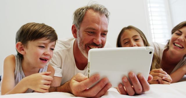 Family Enjoying Quality Time Together on Tablet - Download Free Stock Images Pikwizard.com