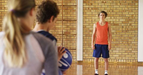 Teenagers Competing in Intense Basketball Game Indoors