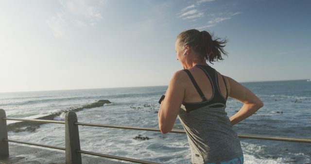 Woman Jogging Along Seafront Promenade at Sunrise - Download Free Stock Images Pikwizard.com