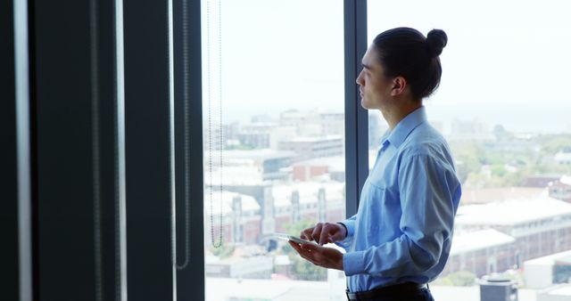 Business Professional Looking Through Office Window Holding Tablet - Download Free Stock Images Pikwizard.com