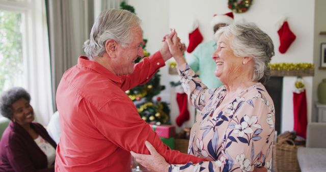 Senior Couple Dancing Joyfully During Christmas Celebration - Download Free Stock Images Pikwizard.com